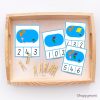 Montessori continent counting cards in a wooden tray with clothespins for matching numbers, designed for preschool counting and geography activities.