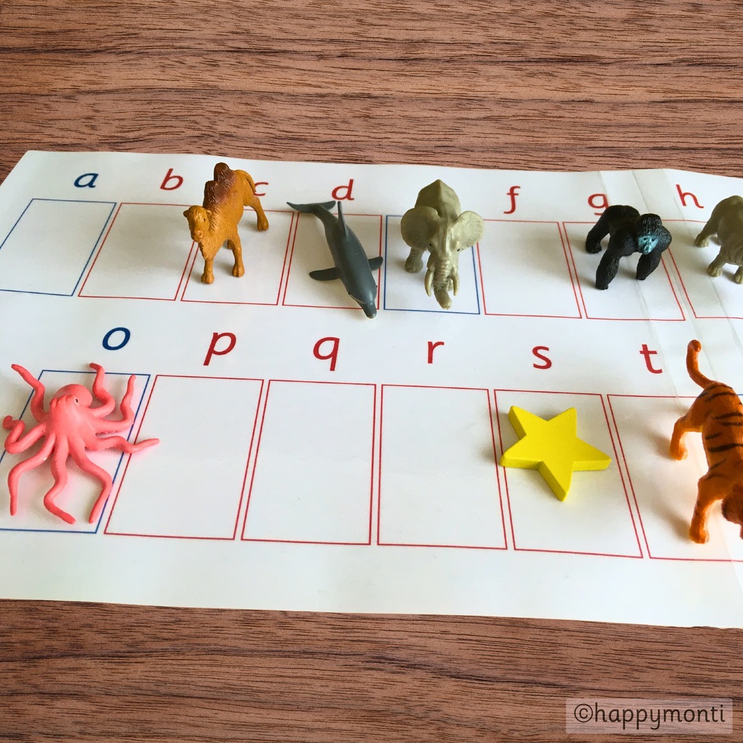 Printable Alphabet Mats_Phonetic Objects_ Alphabet Work Mat_ Montessori Language Mats Montessori alphabet work mat with lowercase letters and phonetic objects like animals and a star. Hands-on language activity for teaching phonetic sounds and letter recognition. Designed by happymonti.